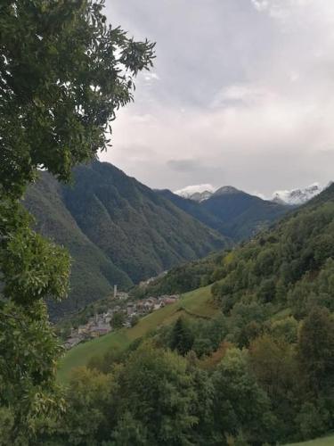 a view of a valley with snow capped mountains at Graziosa, Casetta in Valgerola in Rasura