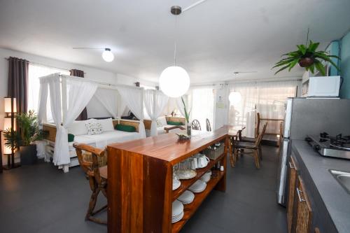 a kitchen and living room with a table with dishes on it at 8 Colors Beach House Resort in Boracay