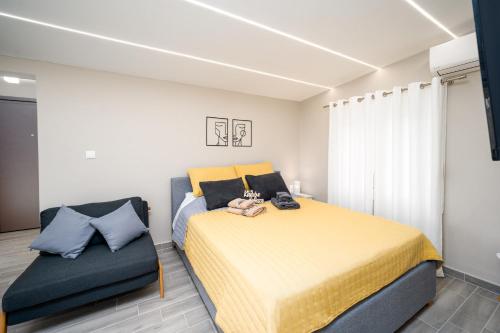 a bedroom with a large bed and a chair at John's city center roof studio flat -panorama view in Aigio
