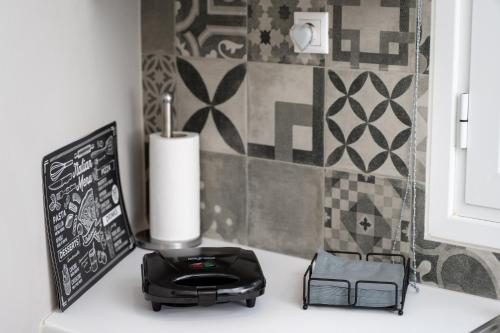 a kitchen counter with a black appliance and a chalkboard at John's city center roof studio flat -panorama view in Aígio
