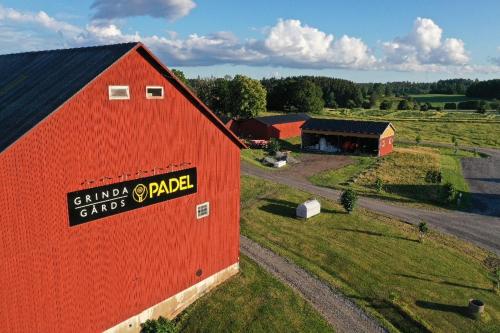 an aerial view of a red barn and a farm at Östra Flygeln Grinda Säteri in Malmköping