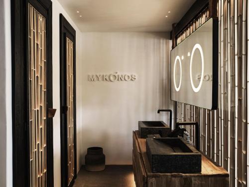a dressing room with a hyundai sign on the wall at Myconian O, a Member of Design Hotels in Ornos