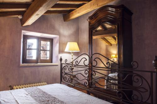 a bedroom with a bed with a large mirror at Tenuta Vento di Mare in Lido Di Fondi