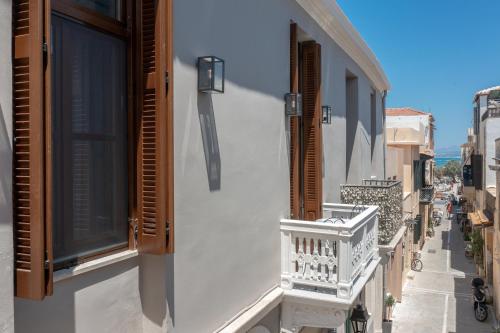 a balcony of a building with a window and a street at Marea Boutique Suites in Rethymno Town