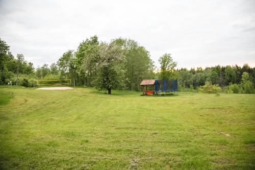 a large field with a playground and a goal at Weavers' Guest House Kalndaki in Milzkalne