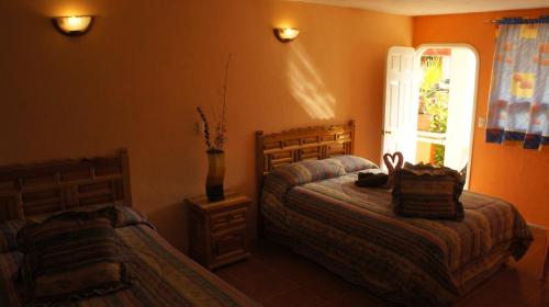 Postel nebo postele na pokoji v ubytování Hotel Posada Tolteca