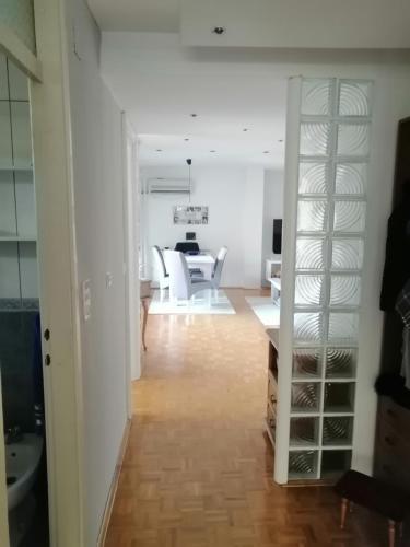 a living room and dining room with a glass shelf at HomeB&E in Tuzla