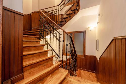 a spiral staircase in a home with wood paneling at Madrid 1915 Private Suites in Madrid