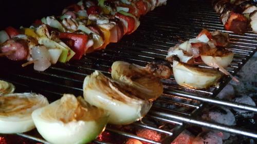 a bunch of food is cooking on a grill at Elitní wellness penzion U Dvou jedlí v srdci Českého ráje in Turnov