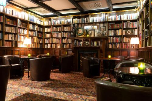 a library with tables and chairs and books at Elite Plaza Hotel Malmö in Malmö