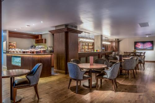 a restaurant with tables and chairs and a bar at Fairmont St Andrews, Scotland in St. Andrews