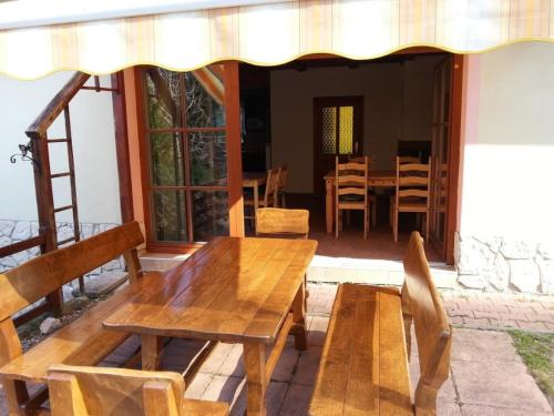 a dining room with a wooden table and chairs at Elitní wellness penzion U Dvou jedlí v srdci Českého ráje in Turnov