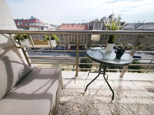 a balcony with a table and a view of a city at Budapest - Duna part in Budapest