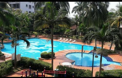 a view of a large swimming pool with palm trees at Century Mahkota Apartments in Melaka