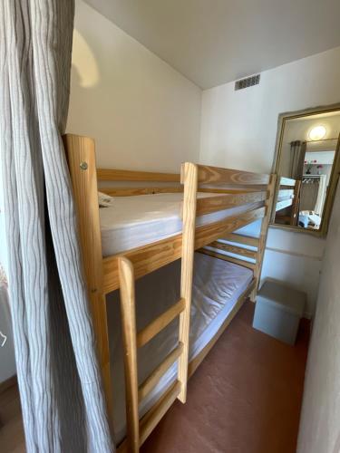two bunk beds in a room with a mirror at U064 - La marmotte enchantée - Gréolières les Neiges in Gréolières