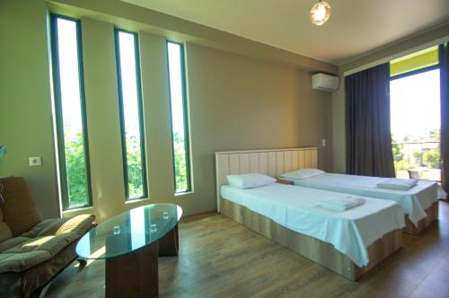 a hotel room with a bed and a glass table at Delta Hotel in Ureki