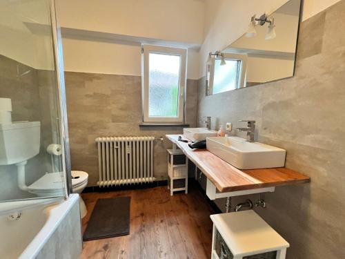 a bathroom with a sink and a mirror at Sarah's Zugspitz Inn in Garmisch-Partenkirchen