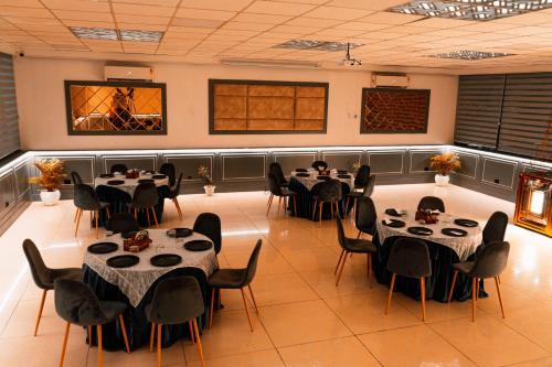 a dining room with tables and chairs in it at Hotel Doon's Pride in Dehradun