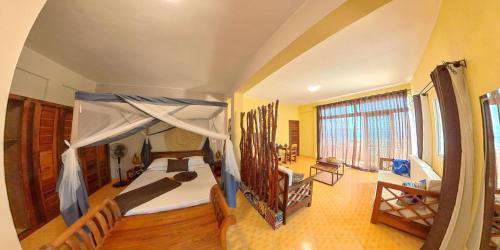 a bedroom with a bed with a canopy at Hôtel de rêve Nosy Komba in Nosy Komba