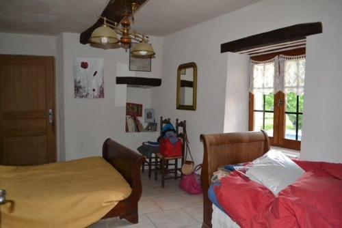 ein Schlafzimmer mit einem Bett und einem Tisch darin in der Unterkunft Deux chambres d hôtes attenantes avec salon salle à manger privatif en Cévennes Gardoises in Saint-Jean-du-Gard