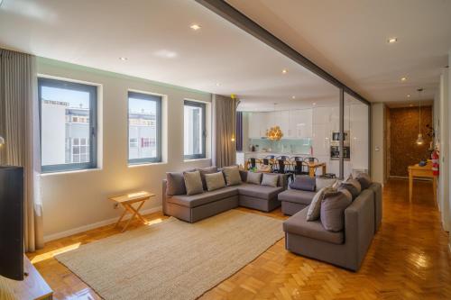 a living room with two couches and a kitchen at Feel Porto Vintage Townhouses in Porto