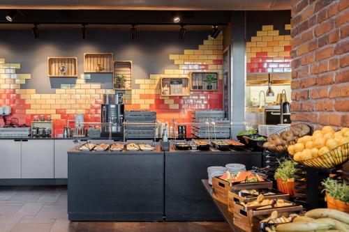 a kitchen with a bunch of food on a counter at Solo Sokos Hotel Torni Tampere in Tampere