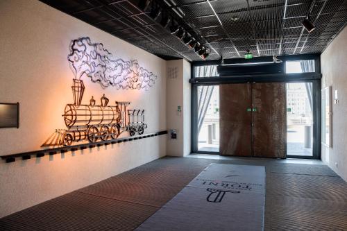 a room with a mural of a train on the wall at Solo Sokos Hotel Torni Tampere in Tampere