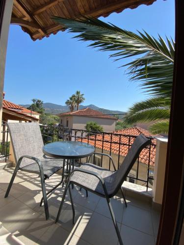 a patio with a table and chairs on a balcony at Roxani Studios-Apartments in Petra