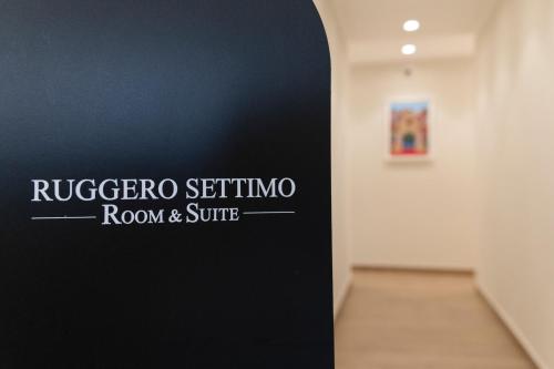a sign that reads rugiger sergio room and suite at B&B Ruggero Settimo - Room & Suite in Palermo