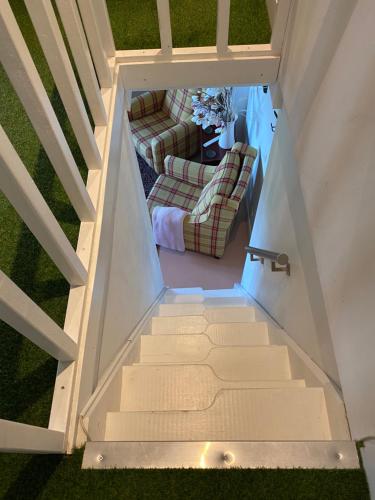 an overhead view of a staircase with a living room at Erve Het Roolvink Boerderij Appartementen 40-50 M2 in Enschede