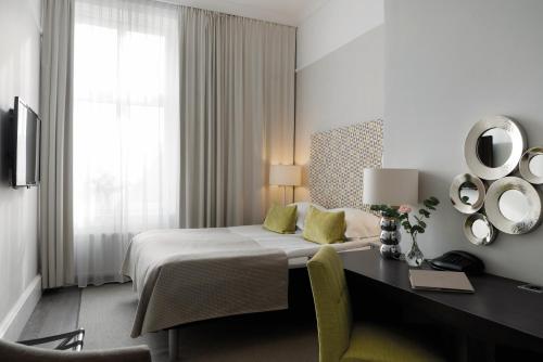 Postel nebo postele na pokoji v ubytování Elite Grand Hotel Gävle