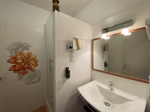 a bathroom with a sink and a mirror at Hôtel Le Colombier in Moustiers-Sainte-Marie