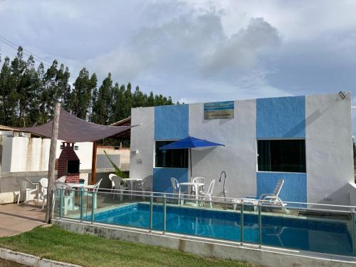 a villa with a swimming pool and a house at Gravatá beach flats in São José da Coroa Grande