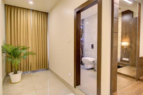 a bathroom with a toilet and a mirror at Cygnett Inn Trendz in Itānagar