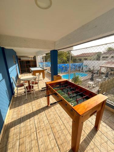 a pool table on a patio with a table at Pousada Loft Praia dos Anjos in Arraial do Cabo