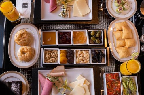 a table topped with plates of food and drinks at Key Hotel in İzmir