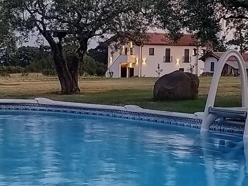 a swimming pool with a house in the background at Agriturismo Casale Lisalola in Sutri