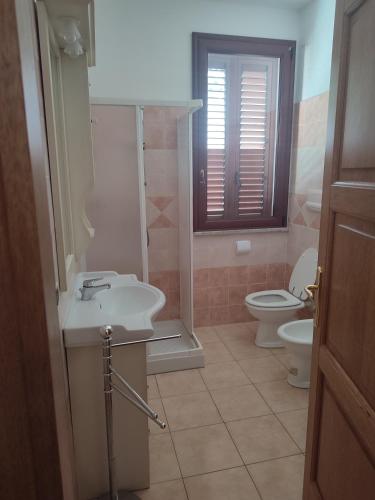 a bathroom with a sink and a toilet at ESTATE IN SARDEGNA in La Caletta