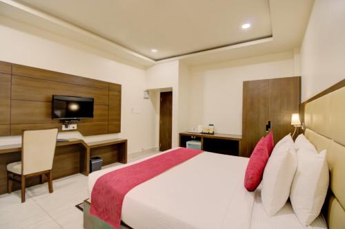 a hotel room with a bed and a desk at Cygnett Inn Trendz in Itānagar