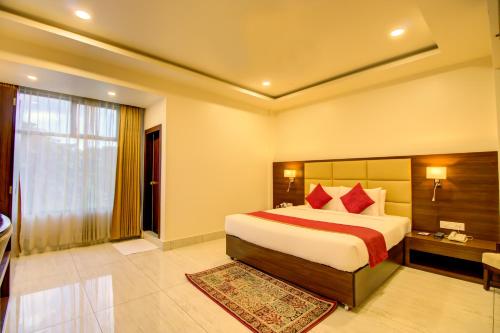 a hotel room with a bed and a window at Cygnett Inn Trendz in Itānagar