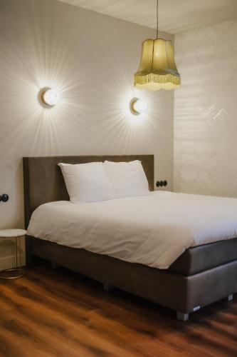 a bedroom with a large bed with white pillows at In de Brouwerij in Leeuwarden