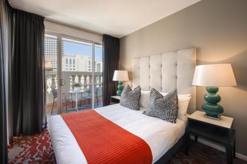 a bedroom with a large bed with a large window at Miller Apartments in Adelaide