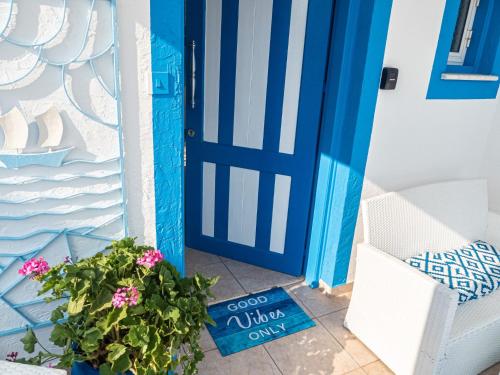 a blue door with a potted plant next to it at Greek Island Style 2 bedroom Villa with Pool next to the Sea in Larnaca
