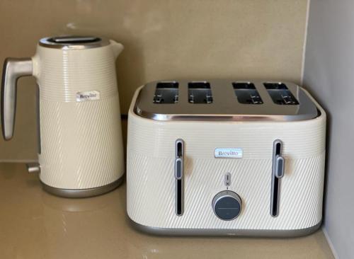 a toaster and a coffee pot sitting on a counter at 2 Bedroom Lux Apartment in Hendon- New Build in Colindale