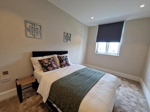a bedroom with a large bed with a window at 2 Bedroom Lux Apartment in Hendon- New Build in Colindale