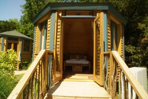 a wooden house with a bed inside of it at West Lexham Retreat in Kings Lynn