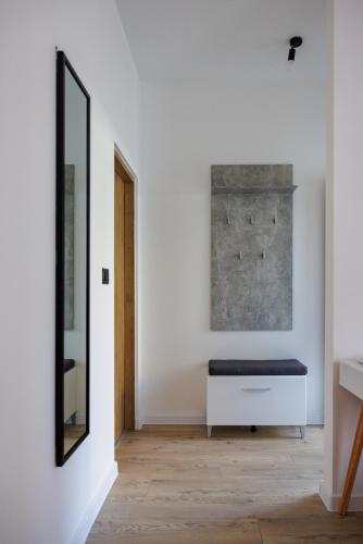 a room with a bench and a mirror at Rooms Lišnić in Osijek