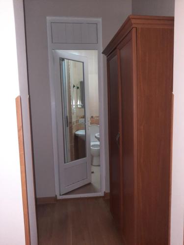 a bathroom with a toilet and a mirror at Delta Hotel in Ureki