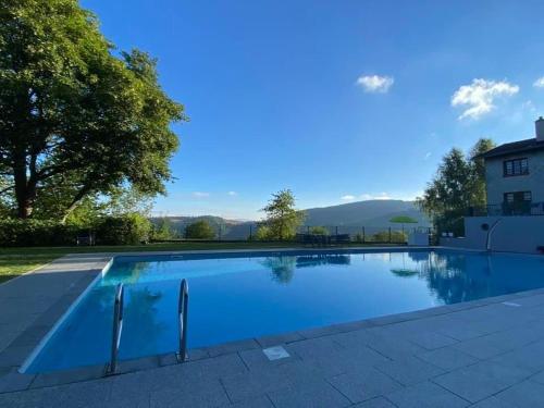 a large swimming pool in a yard next to a house at Gîte de montagne -Bellefosse Alsace in Bellefosse