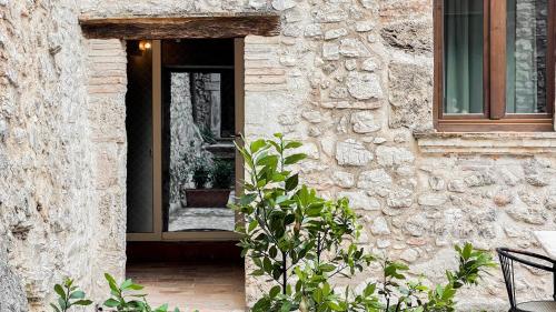 a door of a stone building with a plant at Borgo San Valentino in Arrone